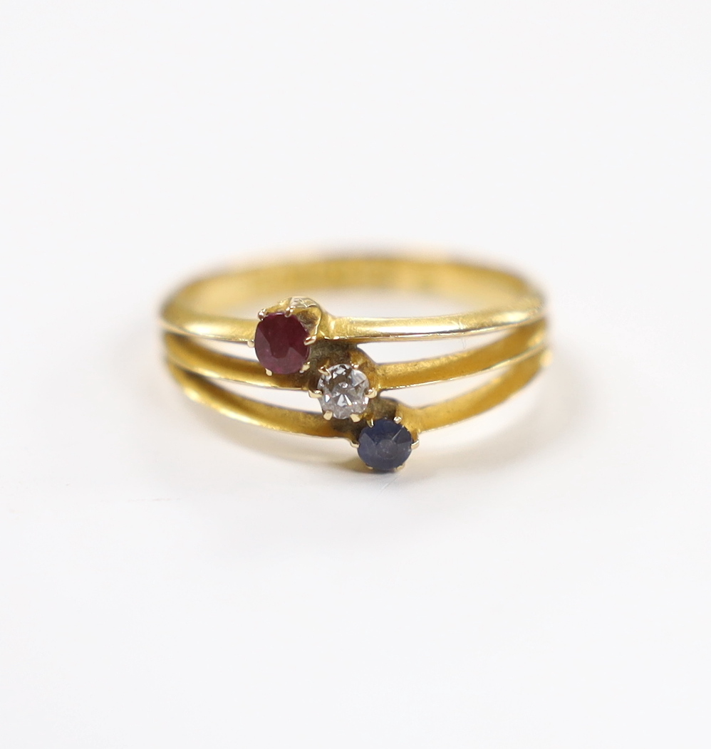 A late Victorian 18ct gold, sapphire ruby and diamond set three stone triple shank ring, size N, gross weight 2.9 grams.